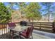 Wooden deck featuring a table with chairs and a grill at 610 Amberwood Pl, Euharlee, GA 30145