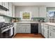 Classic kitchen with grey cabinets, stainless range, and window over the sink at 610 Amberwood Pl, Euharlee, GA 30145