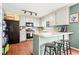 Charming kitchen with grey cabinets, black appliances, and breakfast bar at 610 Amberwood Pl, Euharlee, GA 30145