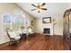 Bright living room featuring large windows, hardwood floors, a cozy fireplace, and elegant decor for comfortable living at 610 Amberwood Pl, Euharlee, GA 30145