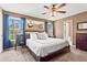 Spacious main bedroom with large windows, ensuite access, and ceiling fan at 610 Amberwood Pl, Euharlee, GA 30145
