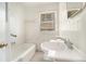 An all white bathroom including a sink, toilet and bath with classic tile at 1833 Ridgeland Dr, Decatur, GA 30032