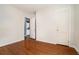 Bedroom with hardwood floors with a closet and entry to the adjacent laundry room at 1833 Ridgeland Dr, Decatur, GA 30032