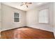 Bedroom features hardwood floors, two windows, and a ceiling fan at 1833 Ridgeland Dr, Decatur, GA 30032