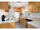 Efficient kitchen layout with wood cabinets, white appliances, and a double stainless steel sink at 1833 Ridgeland Dr, Decatur, GA 30032