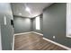 Finished basement showing wood-look flooring and a window with blinds at 5166 Ridge Tarn, Acworth, GA 30102