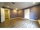 Finished basement with wood-look floors, a white door, and ample space at 5166 Ridge Tarn, Acworth, GA 30102