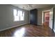 Bedroom showcasing wood flooring, storage cabinet, and a view into the hallway at 5166 Ridge Tarn, Acworth, GA 30102