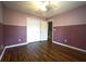 Bedroom showcasing wood flooring, closet space, and a view of the hallway at 5166 Ridge Tarn, Acworth, GA 30102