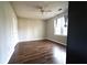 Spacious bedroom with wood flooring, a ceiling fan, and natural light from the window at 5166 Ridge Tarn, Acworth, GA 30102