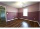 Bedroom featuring two-tone walls, wood flooring, and a view of the hallway at 5166 Ridge Tarn, Acworth, GA 30102