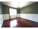 Dining room with dark wood floors, wainscoting, and a chandelier at 5166 Ridge Tarn, Acworth, GA 30102