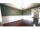 Charming dining room with wainscoting, hardwood floors, and an elegant chandelier at 5166 Ridge Tarn, Acworth, GA 30102