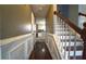 Charming entryway with decorative wainscoting and a staircase leading to the upper level of the home at 5166 Ridge Tarn, Acworth, GA 30102