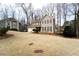 Charming two-story home features a manicured lawn, a two-car garage, and a welcoming red front door at 5166 Ridge Tarn, Acworth, GA 30102