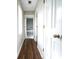 Hallway with hardwood floors leading to bathroom with neutral paint throughout at 5166 Ridge Tarn, Acworth, GA 30102