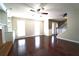 Spacious living room with hardwood floors, a ceiling fan, built-in shelves, and bright natural light at 5166 Ridge Tarn, Acworth, GA 30102