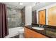 Well-lit bathroom with a granite countertop and a shower-tub combination at 5200 Peachtree Rd # 3403, Atlanta, GA 30341