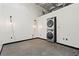 Bright laundry area with exposed ceiling and stacked washer/dryer at 5200 Peachtree Rd # 3403, Atlanta, GA 30341