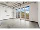 Open living space featuring concrete floors, high ceilings, and large windows at 5200 Peachtree Rd # 3403, Atlanta, GA 30341