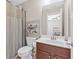 Bathroom featuring shower curtain, metal shelving unit, and dark wood vanity at 5910 Roxboro Ct, Cumming, GA 30040