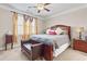 Comfortable bedroom with neutral walls, plush carpeting, ceiling fan, and ample natural light from large windows at 5910 Roxboro Ct, Cumming, GA 30040