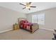 Cozy bedroom with a ceiling fan and a large window providing ample natural light at 5910 Roxboro Ct, Cumming, GA 30040