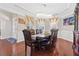 Formal dining room featuring hardwood floors, a decorative chandelier, and large windows at 5910 Roxboro Ct, Cumming, GA 30040