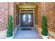 Charming front entryway with a double door and decorative plants creating a welcoming ambiance at 5910 Roxboro Ct, Cumming, GA 30040