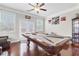 Well-lit game room features a pool table, hardwood floors, and ample natural light from large windows at 5910 Roxboro Ct, Cumming, GA 30040