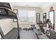 Well-equipped home gym with treadmill, stationary bike, weights, and mirrors at 5910 Roxboro Ct, Cumming, GA 30040