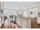 Spacious kitchen featuring white cabinets, stainless steel appliances, and a central island with a sink and dishwasher at 5910 Roxboro Ct, Cumming, GA 30040