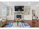 Bright living room with a stone fireplace flanked by custom built-in shelving at 5910 Roxboro Ct, Cumming, GA 30040