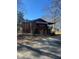 View of a property's backyard with a wooden back porch, chain link fence and weathered exterior at 1033 Mclendon Dr, Decatur, GA 30033