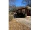 Property view featuring a home with a driveway, set among the trees at 1033 Mclendon Dr, Decatur, GA 30033