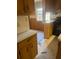 Classic kitchen showing wood cabinets, laminate countertops, and a view into the dining room at 1033 Mclendon Dr, Decatur, GA 30033