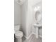 Bathroom features toilet and pedestal sink, a small but functional space at 162 Springbottom Dr, Lawrenceville, GA 30046