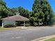 Community pool with a white building to the left, surrounded by trees and green bushes at 162 Springbottom Dr, Lawrenceville, GA 30046