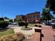 Courtyard area with a decorative fountain, surrounded by a red brick building at 162 Springbottom Dr, Lawrenceville, GA 30046