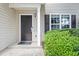 Close up of a traditional front door with side window and green hedges, framed by light-colored siding at 162 Springbottom Dr, Lawrenceville, GA 30046