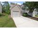 Traditional two-story home showcasing a single-car garage and fresh front lawn with an extended driveway at 162 Springbottom Dr, Lawrenceville, GA 30046