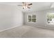 Expansive primary bedroom featuring neutral carpeting, a ceiling fan, and large windows at 162 Springbottom Dr, Lawrenceville, GA 30046