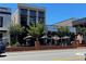 Restaurant exterior featuring outdoor seating with black umbrellas and a brick facade at 162 Springbottom Dr, Lawrenceville, GA 30046