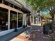 Street-level storefront with large windows, black awnings, sidewalk and trees at 162 Springbottom Dr, Lawrenceville, GA 30046