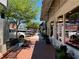 Inviting street view showcasing brick sidewalks lined with shops, benches, and lush greenery under the sunny sky at 162 Springbottom Dr, Lawrenceville, GA 30046