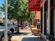 Charming downtown streetscape featuring brick sidewalks, mature trees, and inviting storefronts with red awnings at 162 Springbottom Dr, Lawrenceville, GA 30046