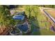 Aerial view of community amenities, including tennis courts, a pond with landscaping, and walking trails at 380 2Nd St, Fayetteville, GA 30214