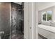 Modern bathroom features a black tiled shower with glass doors at 380 2Nd St, Fayetteville, GA 30214