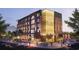 Modern building exterior with brick facade, grand arches, and vibrant street scene at twilight at 380 2Nd St, Fayetteville, GA 30214