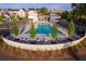 Aerial view of community pool with multiple lounge chairs and mature trees against a backdrop of neighborhood homes at 380 2Nd St, Fayetteville, GA 30214